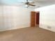 Carpeted bedroom featuring a ceiling fan, and dark-stained doorframe and baseboards at 1990 Spruce Creek N Cir, Port Orange, FL 32128