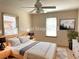 Bedroom featuring neutral walls, bed with modern wood frame and white linens, and bright window at 1990 Spruce Creek N Cir, Port Orange, FL 32128