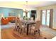 Staged dining area with modern table setting, adjacent to a comfortable living room at 1990 Spruce Creek N Cir, Port Orange, FL 32128