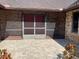 Welcoming brick front entrance with a screen door leading to a brick-paved porch area at 1990 Spruce Creek N Cir, Port Orange, FL 32128
