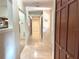 Hallway with beige flooring and wood trim at 1990 Spruce Creek N Cir, Port Orange, FL 32128