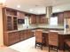 Well-equipped kitchen with ample cabinet space, granite countertops, and a stainless-steel range hood at 1990 Spruce Creek N Cir, Port Orange, FL 32128