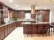 Spacious kitchen featuring custom cabinets, granite countertops, stainless steel appliances, and a large island at 1990 Spruce Creek N Cir, Port Orange, FL 32128