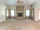Bright living room boasting a decorative fireplace and neutral carpeting at 1990 Spruce Creek N Cir, Port Orange, FL 32128