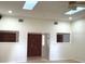 Bright living room featuring skylights, ceiling fan and double-door entryway with sidelights at 1990 Spruce Creek N Cir, Port Orange, FL 32128
