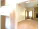 Spacious living room with brick fireplace, neutral carpet, and windows with light-filtering drapes at 1990 Spruce Creek N Cir, Port Orange, FL 32128