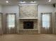 Empty living room with fireplace and neutral carpet with beautiful natural light at 1990 Spruce Creek N Cir, Port Orange, FL 32128