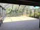 Enclosed patio with wood flooring and views of backyard landscaping at 1990 Spruce Creek N Cir, Port Orange, FL 32128