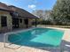 Stunning pool with brick patio, features a ladder, a satellite dish, and a well-maintained backyard at 1990 Spruce Creek N Cir, Port Orange, FL 32128