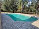 Private in-ground pool with paved patio at 1990 Spruce Creek N Cir, Port Orange, FL 32128