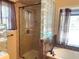 Bathroom featuring glass block window, shower with glass door and soaking tub at 1990 Spruce Creek N Cir, Port Orange, FL 32128