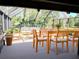 Bright sunroom with outdoor views, dining table and seating at 1990 Spruce Creek N Cir, Port Orange, FL 32128