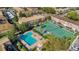 Aerial view of a pool and tennis court surrounded by condo units at 200 Saint Andrews Blvd # 2804, Winter Park, FL 32792
