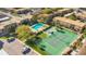 Aerial view showcasing the pool, tennis court, and manicured green spaces within the complex at 200 Saint Andrews Blvd # 2804, Winter Park, FL 32792