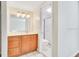Bathroom with a wooden vanity and a shower behind a sliding glass door at 200 Saint Andrews Blvd # 2804, Winter Park, FL 32792