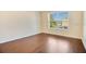 Bright bedroom features wood floors and large window letting in natural light at 200 Saint Andrews Blvd # 2804, Winter Park, FL 32792