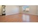 A bright bedroom with wood floors features a stacked washer and dryer for convenience at 200 Saint Andrews Blvd # 2804, Winter Park, FL 32792