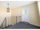 A front door and wrought iron railing are lit by a decorative chandelier in the entryway at 200 Saint Andrews Blvd # 2804, Winter Park, FL 32792