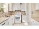 Efficiently designed kitchen boasts modern appliances and a charming backsplash at 200 Saint Andrews Blvd # 2804, Winter Park, FL 32792