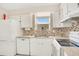 An efficient kitchen features white cabinets and modern appliances at 200 Saint Andrews Blvd # 2804, Winter Park, FL 32792