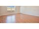 Bright and spacious living room featuring hardwood flooring and a large window for natural light at 200 Saint Andrews Blvd # 2804, Winter Park, FL 32792