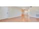An empty living room features glossy wood floors, neutral walls, and natural light from the entry at 200 Saint Andrews Blvd # 2804, Winter Park, FL 32792