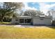 The home features solar panels, a back patio, and a spacious backyard, perfect for outdoor activities at 2044 7Th Ave, Deland, FL 32724