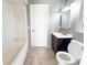 Small bathroom with a sink and vanity combo, toilet, and combination shower and bath at 2044 7Th Ave, Deland, FL 32724