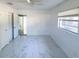 This bedroom features a ceiling fan, tile flooring, and natural light from a window at 2044 7Th Ave, Deland, FL 32724