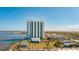 Stunning aerial view showcasing the waterfront condo, pool, and the surrounding cityscape and waterway at 241 Riverside Dr # 207, Daytona Beach, FL 32117