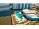 Aerial view of a community pool area with seating and landscaping at 241 Riverside Dr # 207, Daytona Beach, FL 32117