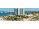 Stunning aerial view of luxury condo building by the water with parking, gardens and beautiful landscaping at 241 Riverside Dr # 207, Daytona Beach, FL 32117