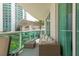 Cozy balcony with outdoor seating and serene views of the building and landscaping at 241 Riverside Dr # 207, Daytona Beach, FL 32117