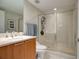 Bathroom with a glass enclosed shower, wood cabinets, and a stone countertop at 241 Riverside Dr # 207, Daytona Beach, FL 32117