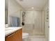 Bathroom featuring a glass enclosed shower, wood cabinets, and stone countertops at 241 Riverside Dr # 207, Daytona Beach, FL 32117