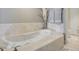 Bathroom featuring a large soaking tub with chrome fixtures and neutral decor at 241 Riverside Dr # 207, Daytona Beach, FL 32117