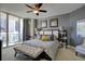 Bedroom features a king bed, large windows, ceiling fan, and comfortable seating at 241 Riverside Dr # 207, Daytona Beach, FL 32117