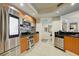 Bright kitchen featuring stainless steel appliances, tile backsplash, and granite countertops with wood cabinetry and a sleek design at 241 Riverside Dr # 207, Daytona Beach, FL 32117