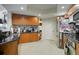 Charming kitchen with wooden cabinets, black countertops, and stainless steel appliances for a blend of style and utility at 241 Riverside Dr # 207, Daytona Beach, FL 32117