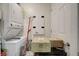 Small, cluttered laundry room with stacked washer and dryer at 241 Riverside Dr # 207, Daytona Beach, FL 32117