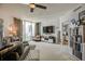 Cozy living room featuring a sliding glass door, neutral walls, and ceiling fan and built in shelving at 241 Riverside Dr # 207, Daytona Beach, FL 32117