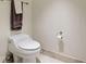 Close up view of the toilet with chrome hardware and brown decorative towels at 241 Riverside Dr # 207, Daytona Beach, FL 32117