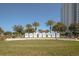 Inviting welcome sign with palm trees, set against a clear blue sky near a modern high-rise building at 241 Riverside Dr # 207, Daytona Beach, FL 32117