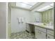 Full bathroom featuring a yellow vanity sink, floral wallpaper, and vanity with ample storage at 28 W Highbanks Rd, Debary, FL 32713