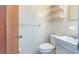 Cozy bathroom with tiled walls, toilet, sink, and shelving provides a functional space at 28 W Highbanks Rd, Debary, FL 32713