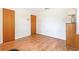 Cozy bedroom with wood-look flooring, white walls, and vintage dresser at 28 W Highbanks Rd, Debary, FL 32713