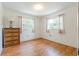 Bedroom showcasing wood-look floors, white walls, and dual windows with curtains at 28 W Highbanks Rd, Debary, FL 32713