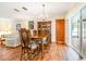 Elegant dining room featuring hardwood floors, chandelier, china cabinet, and sliding glass door at 28 W Highbanks Rd, Debary, FL 32713