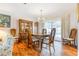 Bright dining area featuring hardwood floors, chandelier, and sliding glass doors to the backyard pool at 28 W Highbanks Rd, Debary, FL 32713