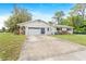 Charming single-story home featuring an attached garage and a well-maintained front lawn at 28 W Highbanks Rd, Debary, FL 32713